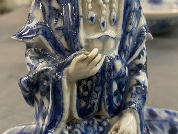 A Chinese blue and white figure of a seated Guanyin, 19th C.